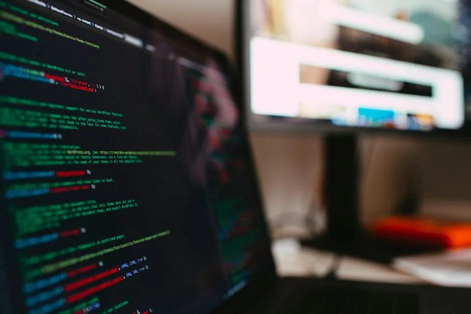 A modern computer screen displaying web design work, showcasing creative visuals in a workspace.