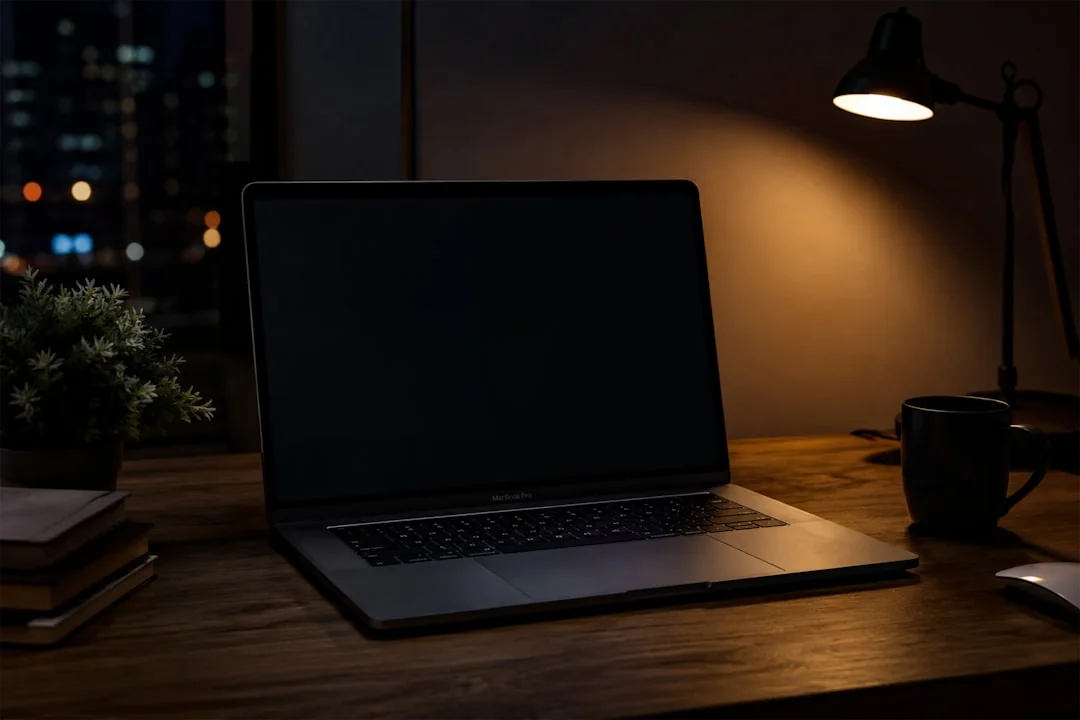 A sleek office desk setup featuring Apple devices: iMac, MacBook, and iPad.